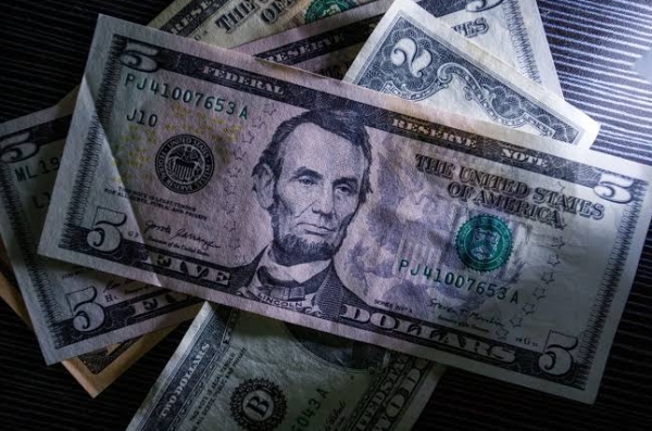 الدولار يتراجع بعد قفزة مدفوعة بقرار الفيدرالي مع انخفاض عوائد السندات والنفط